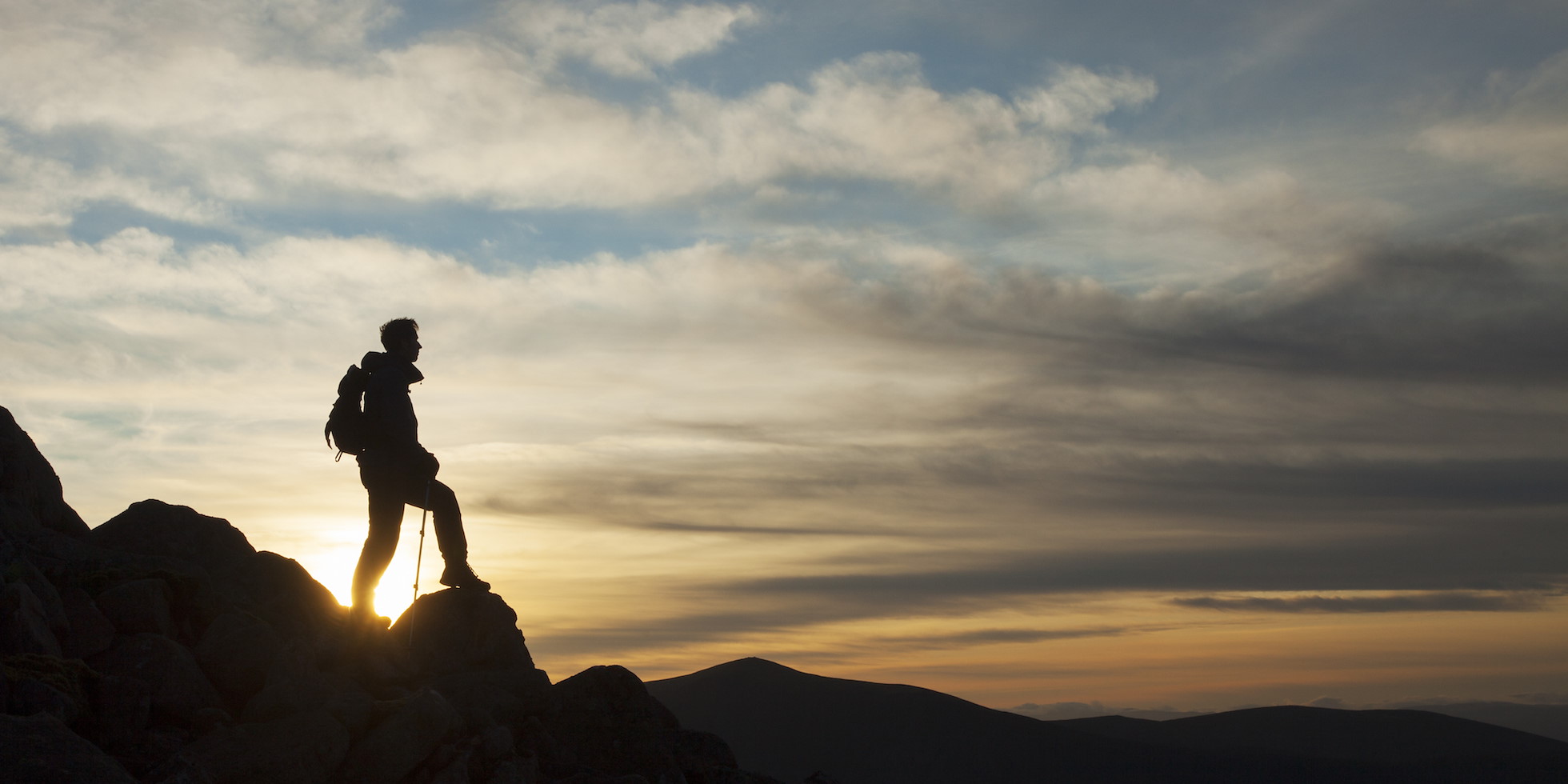 Walker silhouetted at sunset on Braeriach, Cairngorms National Park, Scotland